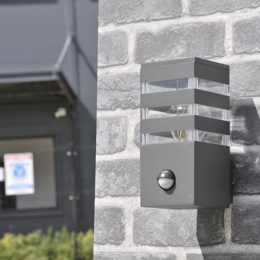 Εξωτερικό επιτοίχιο φωτιστικό με αισθητήρα TEKSAS 1xE27/12W/230V IP44 ανθρακί