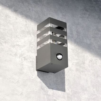 Εξωτερικό επιτοίχιο φωτιστικό με αισθητήρα TEKSAS 1xE27/12W/230V IP44 ανθρακί