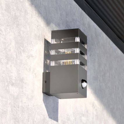 Εξωτερικό επιτοίχιο φωτιστικό με αισθητήρα TEKSAS 1xE27/12W/230V IP44 ανθρακί