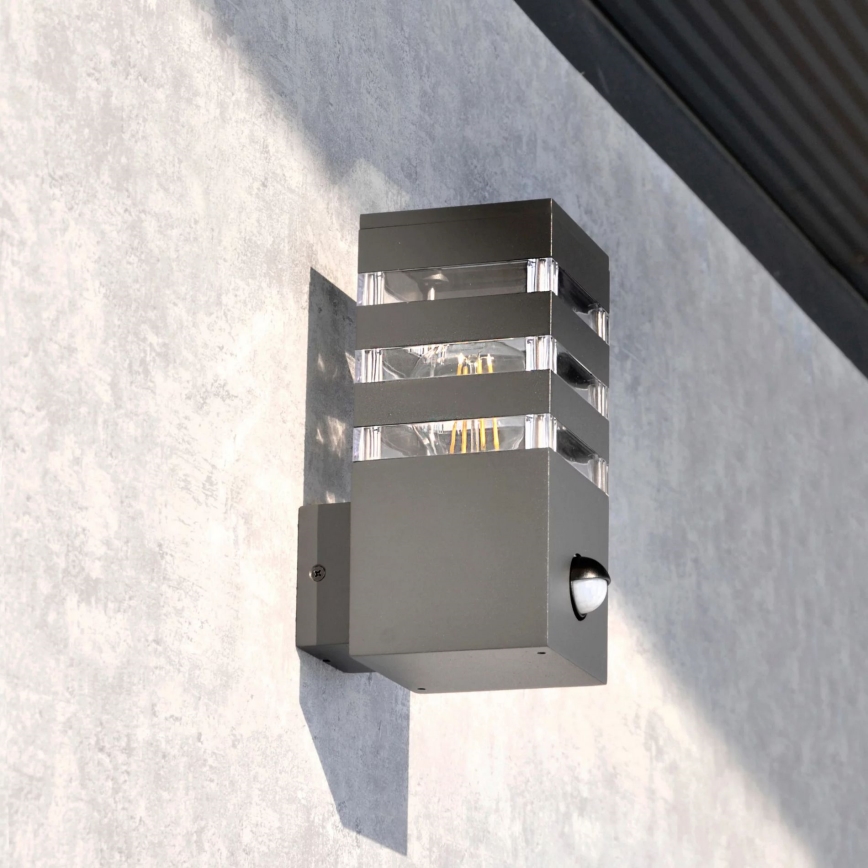 Εξωτερικό επιτοίχιο φωτιστικό με αισθητήρα TEKSAS 1xE27/12W/230V IP44 ανθρακί